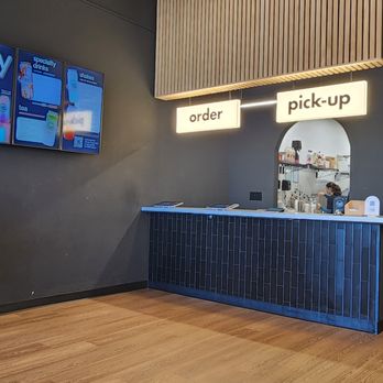 Candy Cloud - Ordering kiosk - A beverage establishment features a counter with digital menu screens on the wall and a designated pick-up area for orders. - Bubble Tea Near Me - Glenview, Illinois