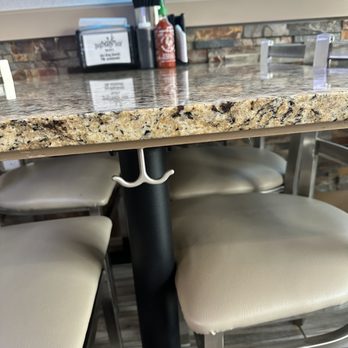 Pho King Noodle Bar - A thoughtful touch allowing a space to hang a purse, or wristlet at the end of each table. - Vietnamese Near Me - Houston, Texas Pho King Noodle Bar - A thoughtful touch allowing a space to hang a purse, or wristlet at the end of each table. - Vietnamese Near Me - Houston, Texas