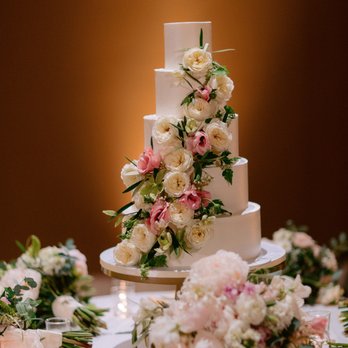 Ma Petite Maison Cake Design - a wedding cake surrounded by flowers - Custom Cakes Near Me