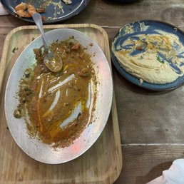 Empty plate of shrimp scampi. Demolished Hummus.