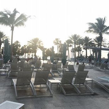 Dock's Pool Bar and Grille - lounge chairs and palm trees - Tiki Bars Near Me - Clearwater, Florida