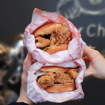 Super Chicken - two hands holding a sandwich - Chicken Shop Near Me - Markham, Ontario