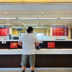 Wells Fargo Bank - Guy on the left taking questions. Only Teller in the middle really working. Other people just walking around looking.