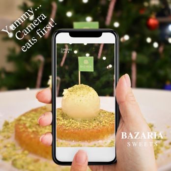 Bazaria Sweets - a person taking a picture of a dessert - Ice Cream & Frozen Yogurt Near Me - Plano, Texas Bazaria Sweets - a person taking a picture of a dessert - Ice Cream & Frozen Yogurt Near Me - Plano, Texas
