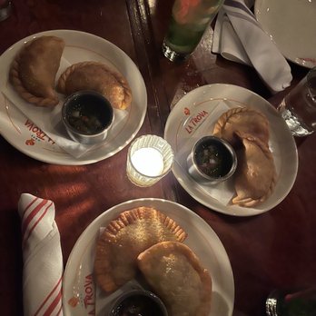 Cafe La Trova - Hand Cut Steak Empanada   Sweet Corn & Chicken Empanada  CUBAN SANDWICH EMPANADAS (THE BEST!!!!) - Cocktail Bars Near Me - Miami, Florida