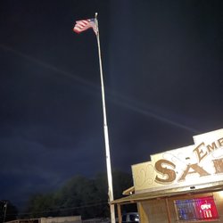 Empty Pockets Saloon - American flag lit up at night