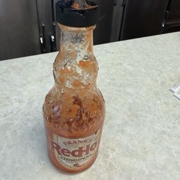 Dirty disgusting bottle of hot sauce Dirty disgusting bottle of hot sauce