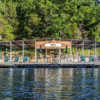 Lake Shore Cabins - Enjoy the swim deck with ladders, lounge chairs, picnic tables and umbrellas! Area to fish, swim, lay in the sun! - Hotels Near Me - Eureka Springs, Arkansas