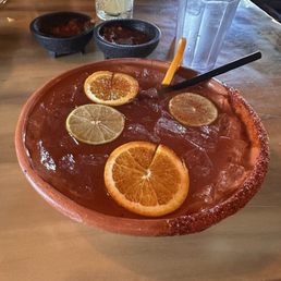A unique drink including tequila in a clay bowl.