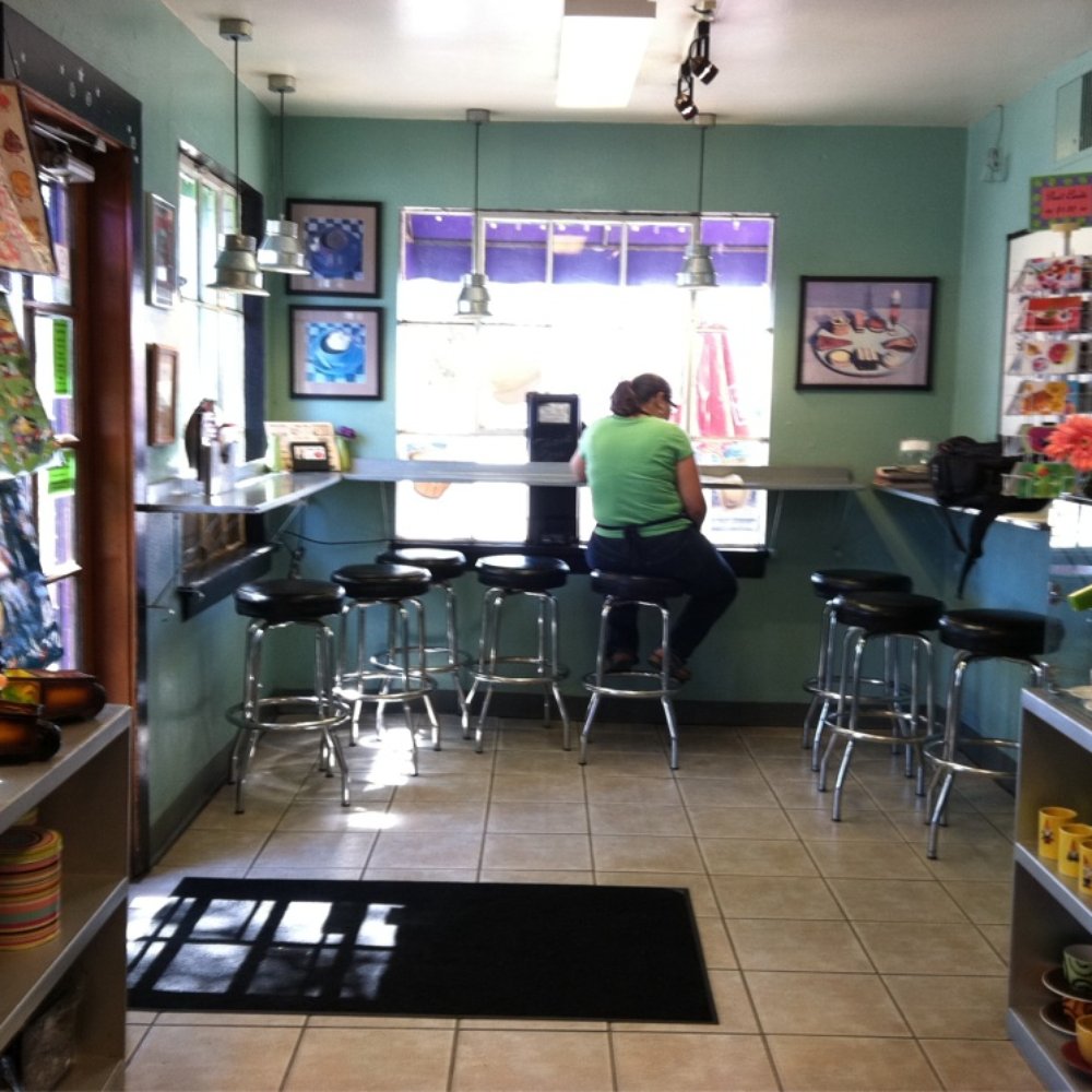 Chocolate Iguana - a woman sitting at a counter - Coffee & Tea Near Me - Tucson, Arizona Chocolate Iguana - a woman sitting at a counter - Coffee & Tea Near Me - Tucson, Arizona