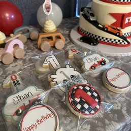 Custom sugar cookies and a two-tiered racing themed cake Custom sugar cookies and a two-tiered racing themed cake