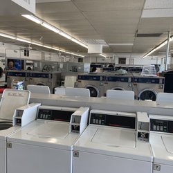 E-Z Wash - Inside of business, washing machines in the middle and dryers along the wall.