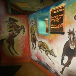 a mural of a cowboy on horseback a mural of a cowboy on horseback