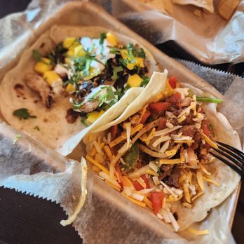Torchy's Tacos - Brushfire chicken taco on left and Steak fajita taco on right - Tex-Mex Near Me - Raleigh, North Carolina Torchy's Tacos - Brushfire chicken taco on left and Steak fajita taco on right - Tex-Mex Near Me - Raleigh, North Carolina