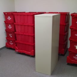 Starting the office move using their plastic crate system. Didn't have to empty the filing cabinet, they were able to move it as is.