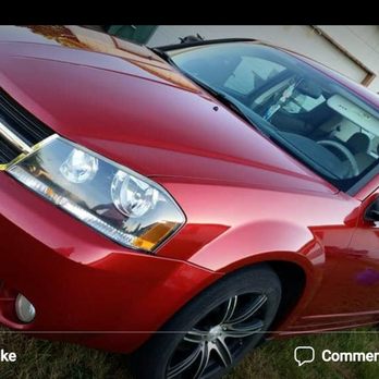 Downtown Automotive - 2008 Dodge Avenger - A red 2008 Dodge Avenger is parked on a concrete surface near a building, with visible front and side views, and a reflection on the windshield. - Auto Repair Near Me - Eugene, Oregon
