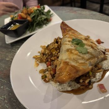 Red Cedar Bistro - Spanakopita on a bed of couscous with an Arugala salad - Mediterranean Near Me - Longmont, Colorado Red Cedar Bistro - Spanakopita on a bed of couscous with an Arugala salad - Mediterranean Near Me - Longmont, Colorado