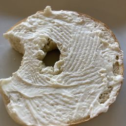 Bagel with skim coating of cream cheese. Bagel with skim coating of cream cheese.