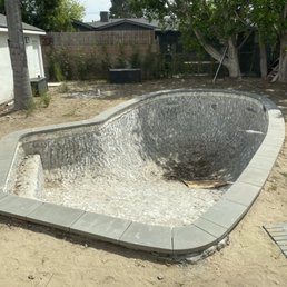 Custom concrete pool coping dark gray modern edge pool remodeling backyard renovation