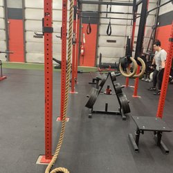 Sport Of Iron Fitness - Power rack with turf strip in background- also, garage doors apparently are open during the warmer months