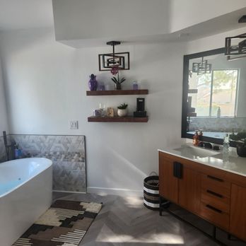 Borja Renovations - a bathroom with a large bathtub - General Contractors Near Me
