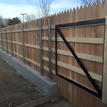 Titan Concrete - a wooden fence with a gate - General Contractors Near Me Titan Concrete - a wooden fence with a gate - General Contractors Near Me