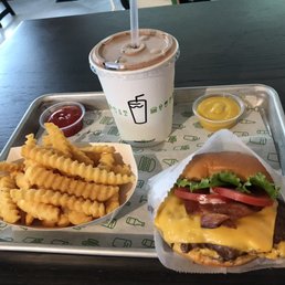 Double cheeseburger with bacon, fries, and a chocolate shake Double cheeseburger with bacon, fries, and a chocolate shake