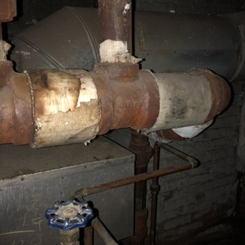 Crown Environmental - Asbestos-containing corrugated pipe insulation on an existing boiler in the basement of a building. - Environmental Testing Near Me Crown Environmental - Asbestos-containing corrugated pipe insulation on an existing boiler in the basement of a building. - Environmental Testing Near Me