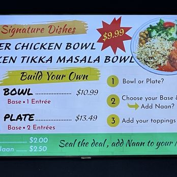SpiceX - Menu board at SpiceX in Washington, DC, featuring signature Indian dishes including Butter Chicken Bowl and Chicken Tikka Masala Bowl priced at $9.99. It offers build-your-own options with choices of bowl or plate, and additional toppings and sides like naan and garlic naan, with prices listed. The board includes step-by-step instructions for customizing meals and a photo of a prepared dish on the right side. - Indian Near Me - Washington, DC, District of Columbia