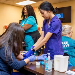Northwest Career College - Henderson - NCC Students practicing hands-on venipuncture blood draws under instructor supervision during phlebotomy training in Las Vegas.