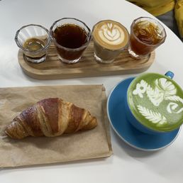 Coffee flight, matcha latte, and raspberry croissant