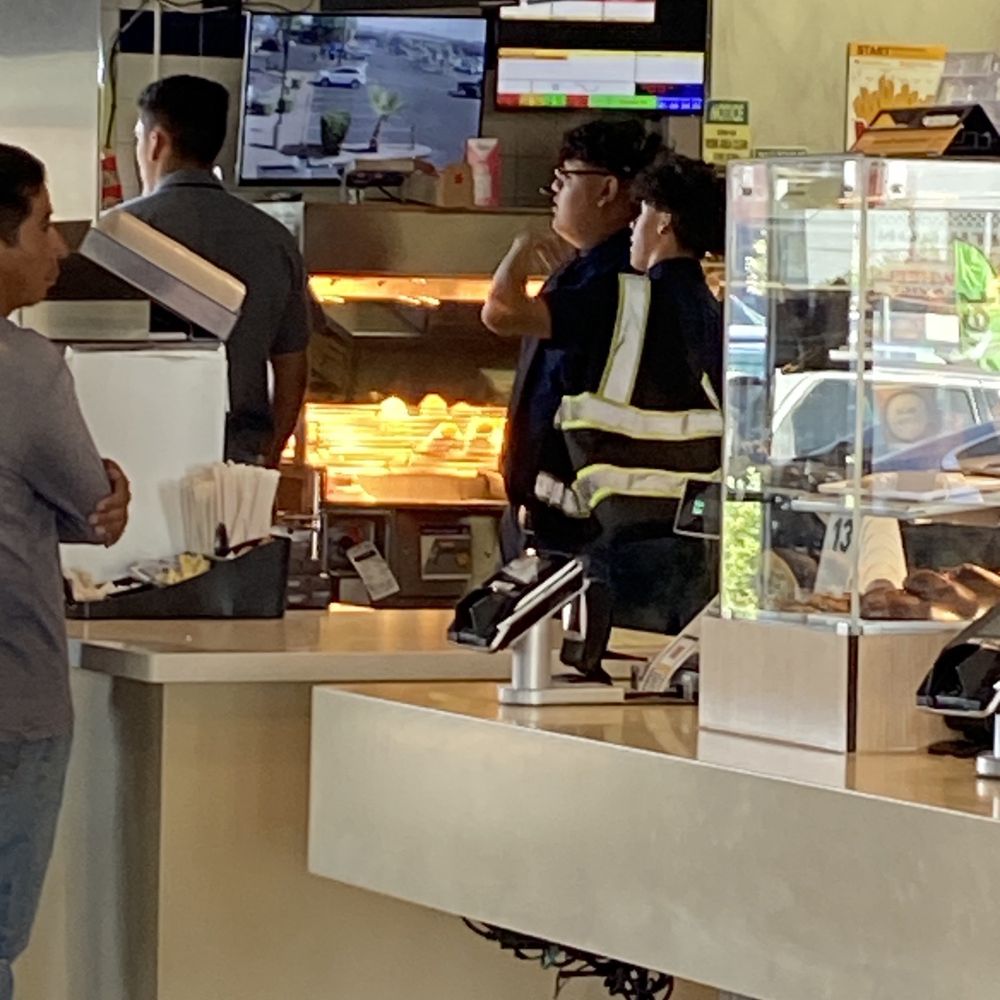 customers at the counter of a fast food restaurant customers at the counter of a fast food restaurant
