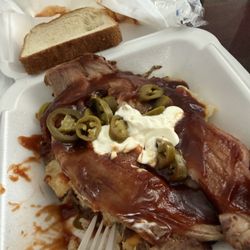 'nooga Q Smokehouse Grill - Loaded Baker with brisket I added jalapeno! Simple flavor but very delicious they cut up the potato which I liked but sliced the brisket.