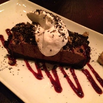 Tzin Wine & Tapas - Chocolate Mousse Tart with Chocolate Cookie Crumb Crust, Almond Brittle Crumble, Whip Cream, and Raspberry Coulis - Wine Bars Near Me - Edmonton, Alberta