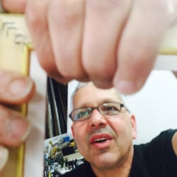 Framing Dragon Picture Company - Owner Rafael framed in action.