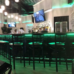 a bar with green lights a bar with green lights