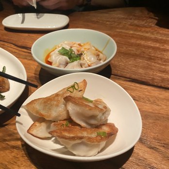 The Bao - Pan Fried Dumplings (front): $12 and Wonton in Chili Oil with pork (back): $9 - Shanghainese Near Me - New York, New York The Bao - Pan Fried Dumplings (front): $12 and Wonton in Chili Oil with pork (back): $9 - Shanghainese Near Me - New York, New York