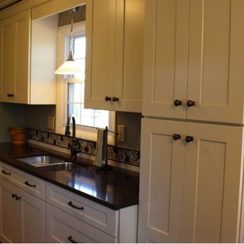 Home Improvement Outlet - a kitchen with white cabinets and black countertops - Flooring Near Me - Lebanon, Pennsylvania Home Improvement Outlet - a kitchen with white cabinets and black countertops - Flooring Near Me - Lebanon, Pennsylvania