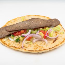Tum Tums Mediterranean - A warm, flavorful gyro loaded with seasoned meat, fresh grilled vegetables, crisp lettuce, and our signature Mediterranean sauce.