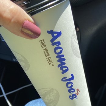 Aroma Joe's - a person holding a cup of coffee - Cafes Near Me - Rochester, New Hampshire