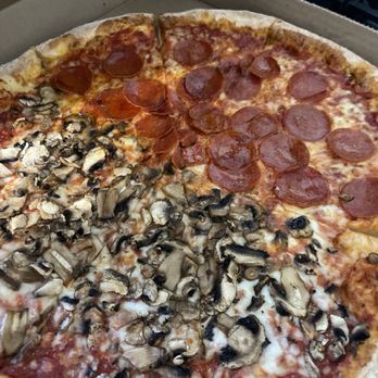 Mano's Pizza - This is the pizza I was expecting!! This is what it used to look like. We are not local and went out of our way to get this pizza today. - A pizza with three different sections features pepperoni slices on one side, mushrooms on another, and a cheese-only section. The pizza is in a cardboard box, showing a baked crust and melted cheese. The toppings are evenly distributed, and the pizza appears freshly baked. - Pizza Near Me - Methuen, Massachusetts