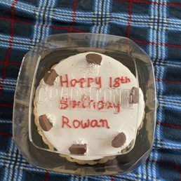 a birthday cake in a plastic container