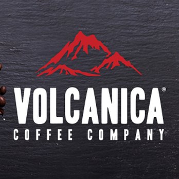 Volcanica Coffee - a cup of coffee next to a pile of coffee beans - Coffee Roasteries Near Me - Suwanee, Georgia