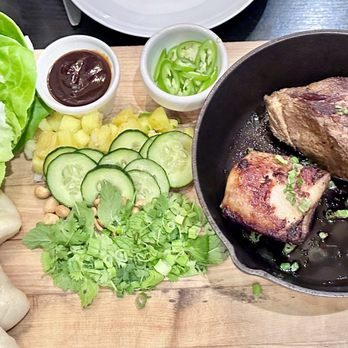 Plonk! Bistro & Wine Cellar - LE COCHON ("THE PIG") Slow-cooked Berkshire pork, steamed buns & lettuce wraps, fresh & flavorful toppings - Wine Bars Near Me - Houston, Texas