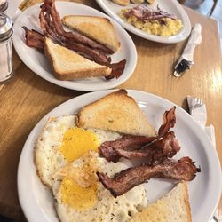 Jay's - Bacon, toast, overcooked, eggs, and extra side of bacon and mini pancakes with scrambled eggs