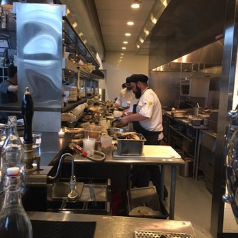 Row 34 - Seaport - Line cook cooking a line caught fish. - New American Near Me - Boston, Massachusetts Row 34 - Seaport - Line cook cooking a line caught fish. - New American Near Me - Boston, Massachusetts