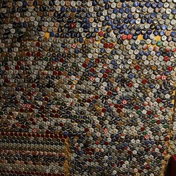 Full Moon Bar & Grill - Men's room lined with bottle caps on walls. - American Near Me - Queensbury, New York Full Moon Bar & Grill - Men's room lined with bottle caps on walls. - American Near Me - Queensbury, New York