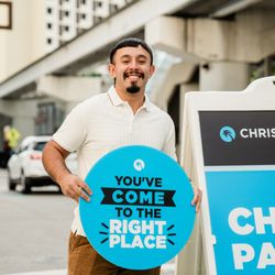 Christ Fellowship Church - Downtown Campus - Person standing outside welcoming people to church and helping them park.