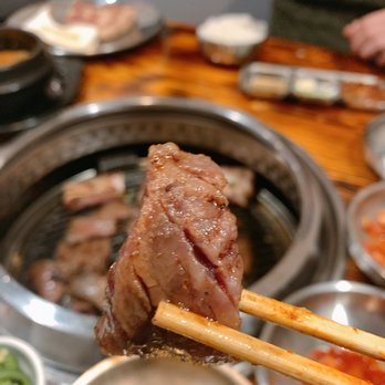 Don Pocha - a person holding chopsticks over a bowl of food - Korean Near Me - Upper Arlington, Ohio Don Pocha - a person holding chopsticks over a bowl of food - Korean Near Me - Upper Arlington, Ohio