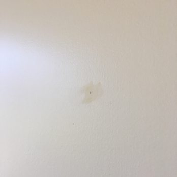 Island Hale Interiors - Hole in the wall made for hanging a painting, you still clearly see where the hole was and their pitiful attempt and covering it - Home Staging Near Me - Kailua, Hawaii Island Hale Interiors - Hole in the wall made for hanging a painting, you still clearly see where the hole was and their pitiful attempt and covering it - Home Staging Near Me - Kailua, Hawaii